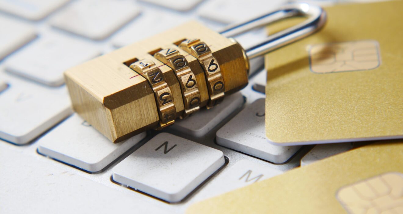 a golden padlock sitting on top of a keyboard